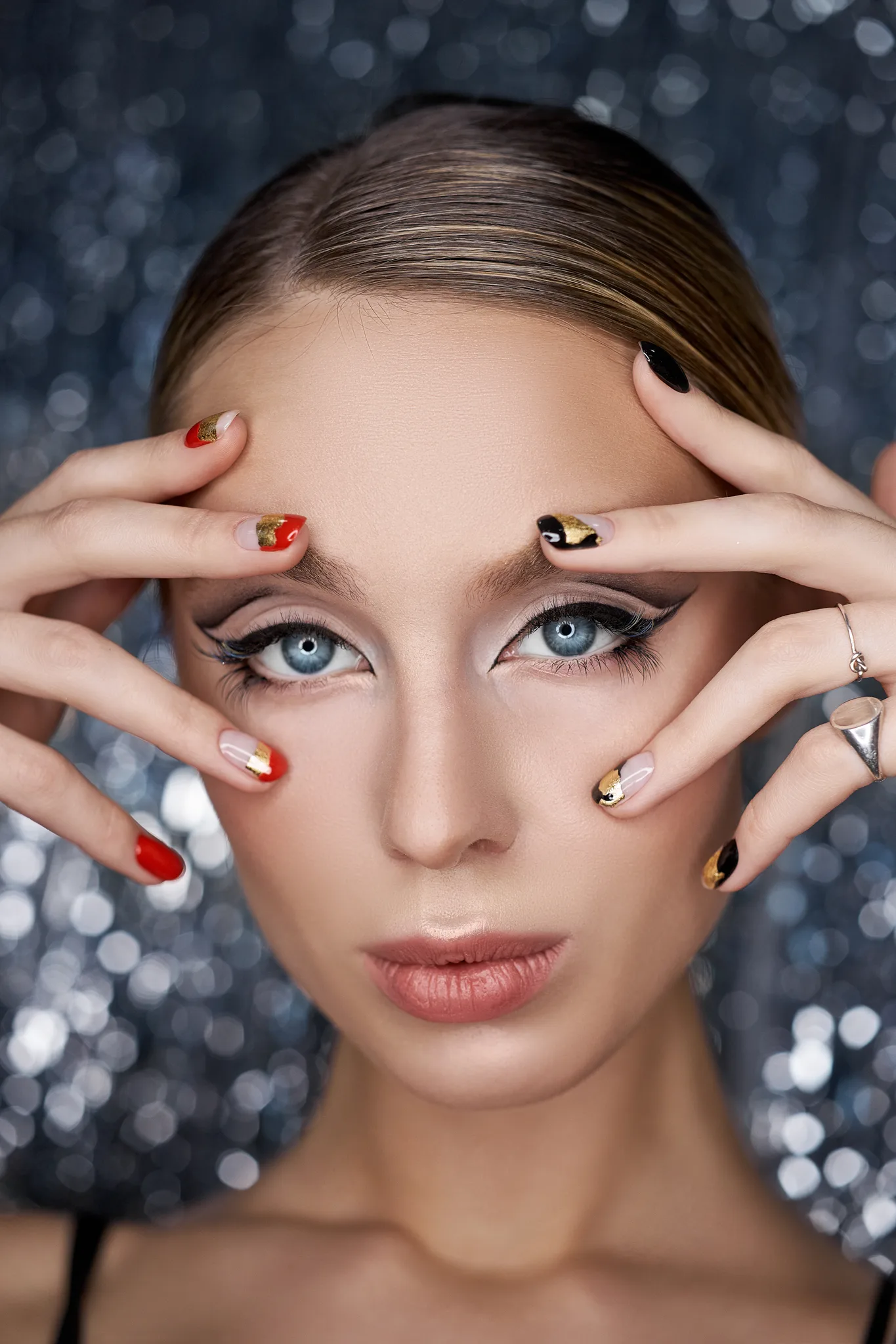 a woman with glitter makeup and nail art